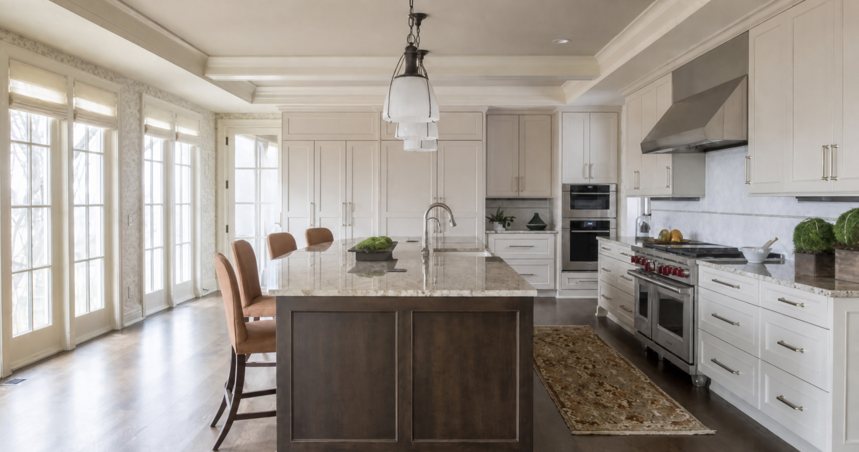Dura Supreme kitchen featuring white perimeter cabinetry and a contrasting dark wood island